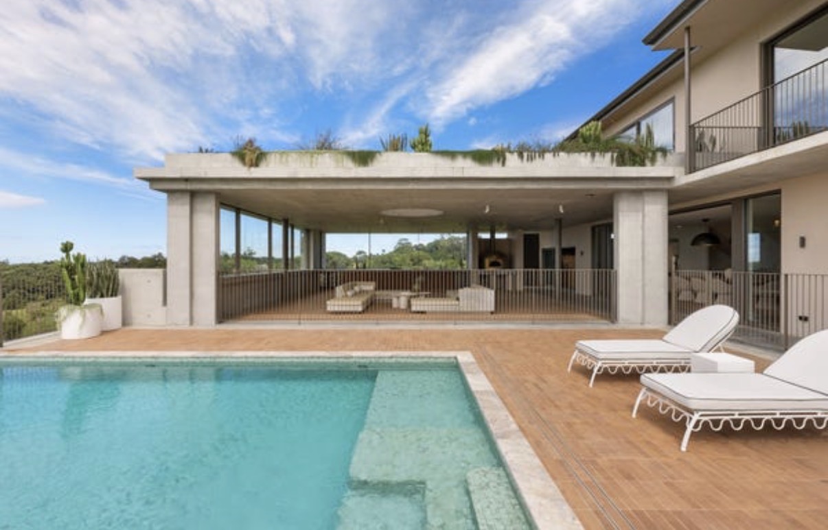Turquoise pool in front of the estate's outdoor terrace