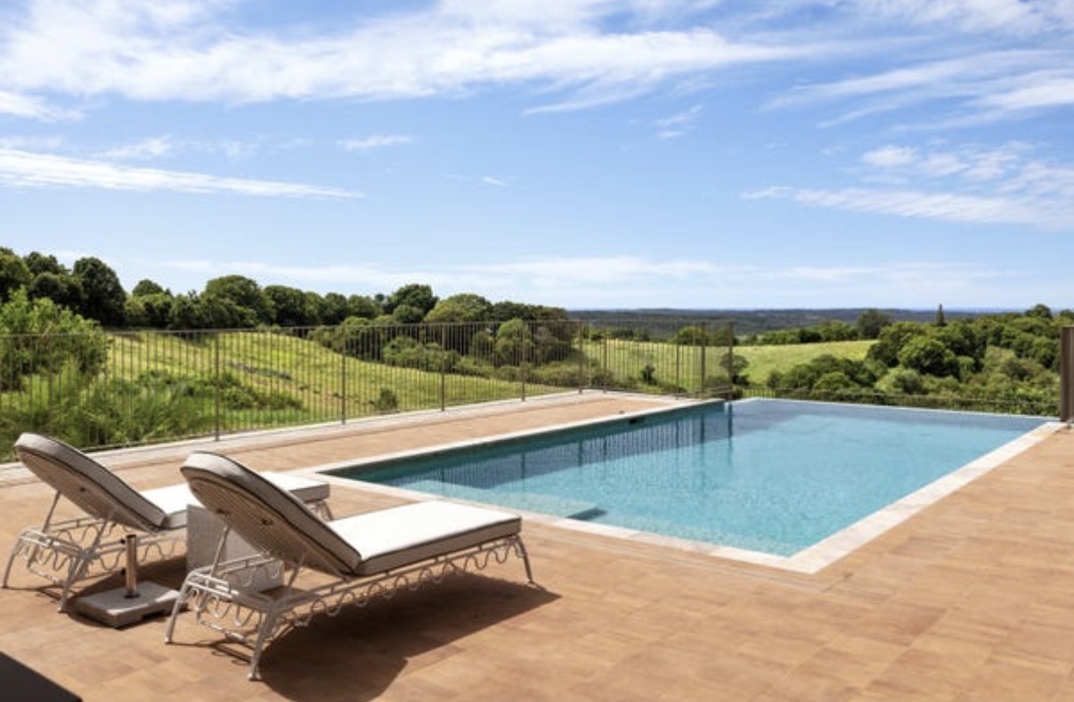 Pool and sun loungers overlooking the Northern Rivers countryside