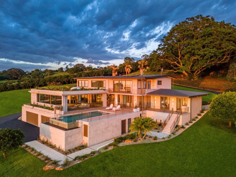 Leadbeatters Lane residence glowing in the evening light, surrounded by green hinterland