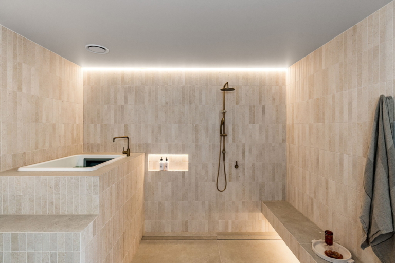 Limestone wellness pavilion with a bath and shower
