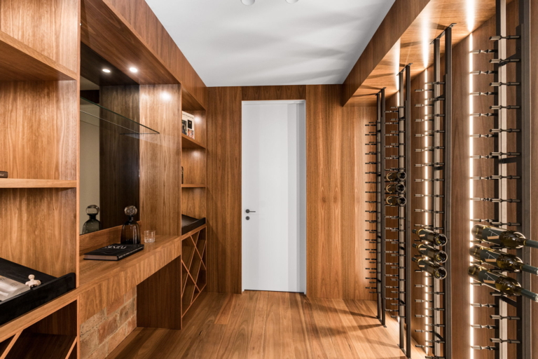 Timber-lined private wine cellar with bottle racks and display shelving