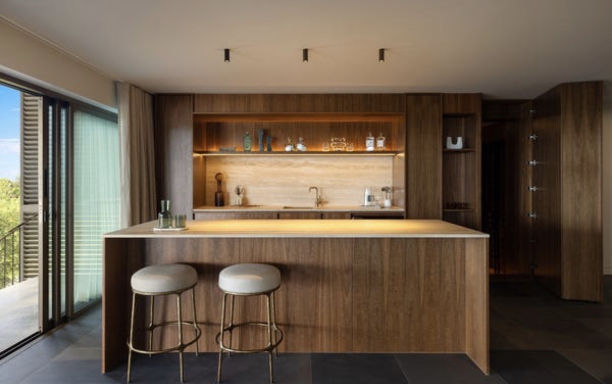 The residence’s second bar with timber cabinetry, stone counter and seating